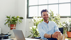 A smiling tax advisor sitting at a desk