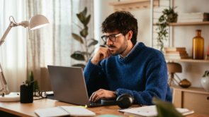 A tax client reviewing documents on his laptop