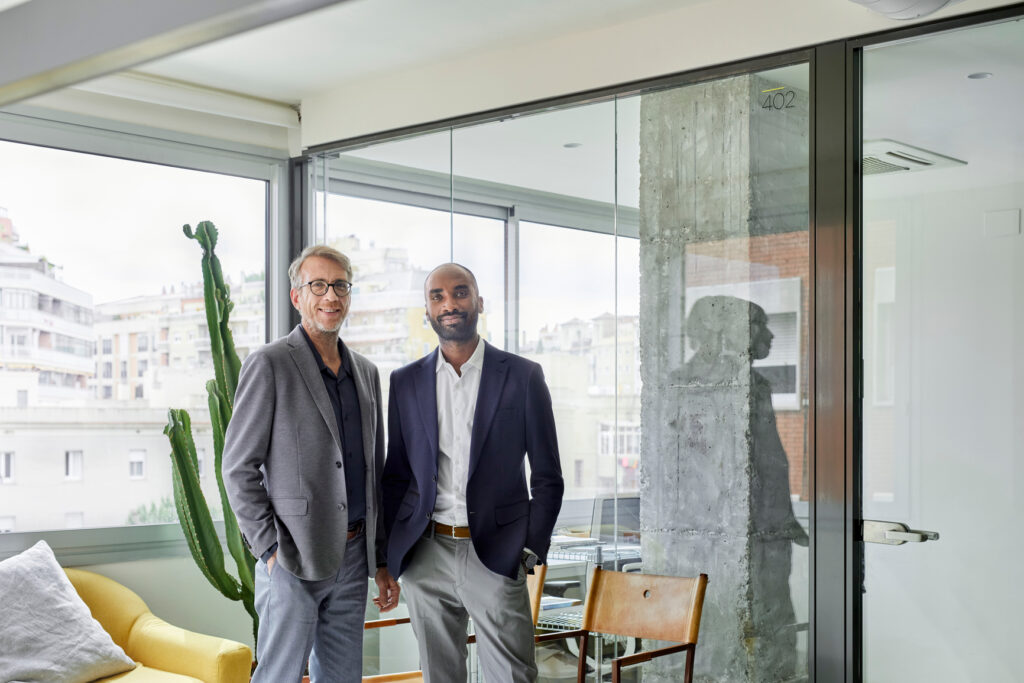 Business partners smiling standing together in an office