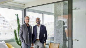 Business partners smiling standing together in an office