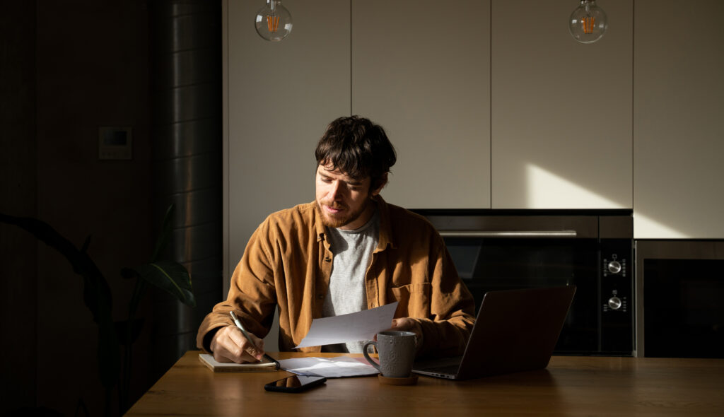 Man at a desk working on personal finances and taxes