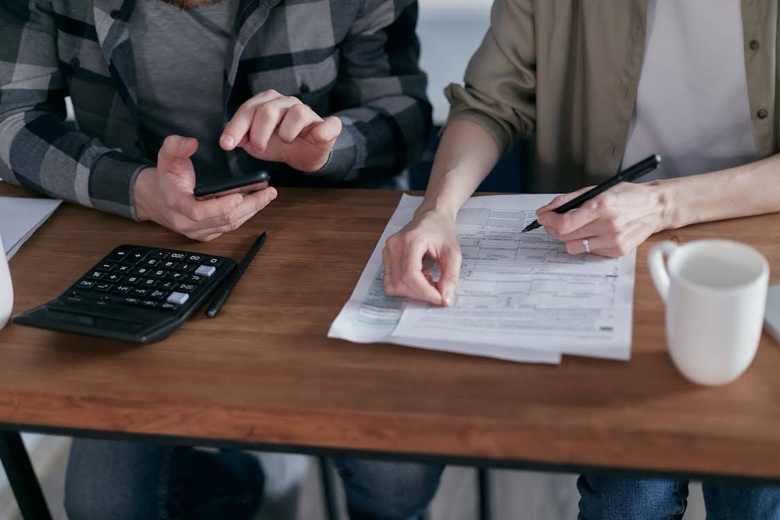 Two people working on tax forms