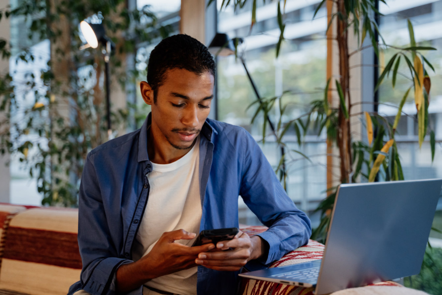 a young adult using his phone