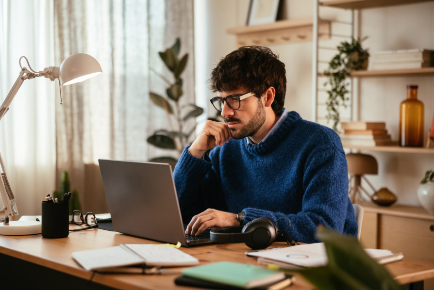 A man sitting at a desk at his home office