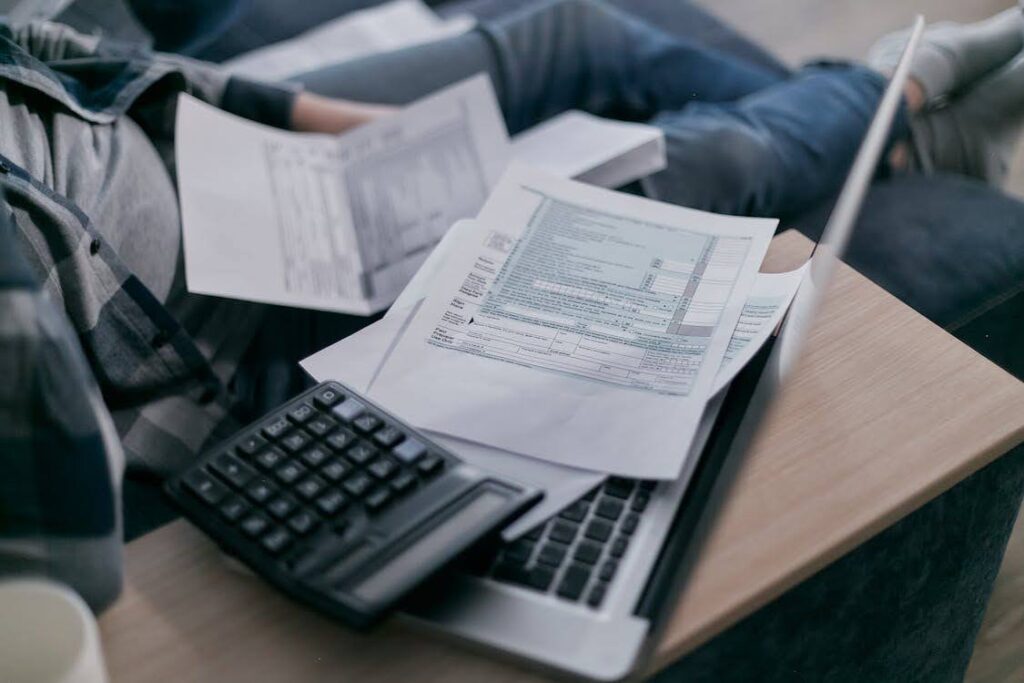 A person overwhelmed by tax documents