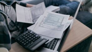 A person overwhelmed by tax documents