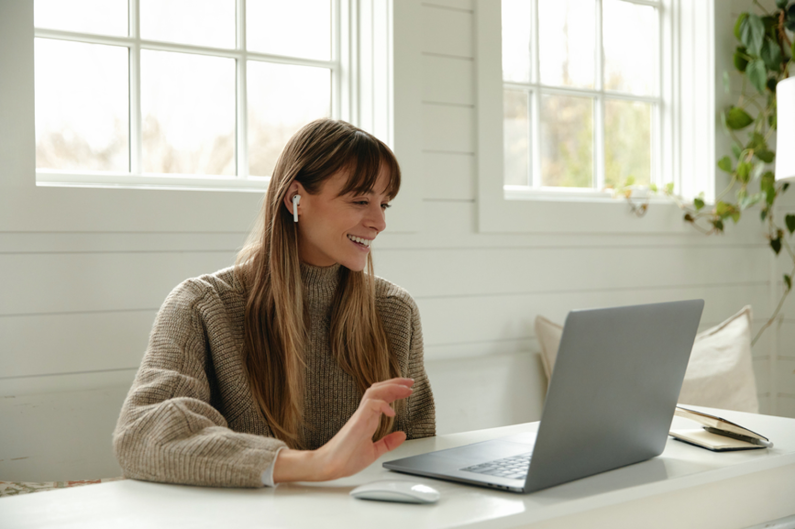 A woman on a video call on a laptop