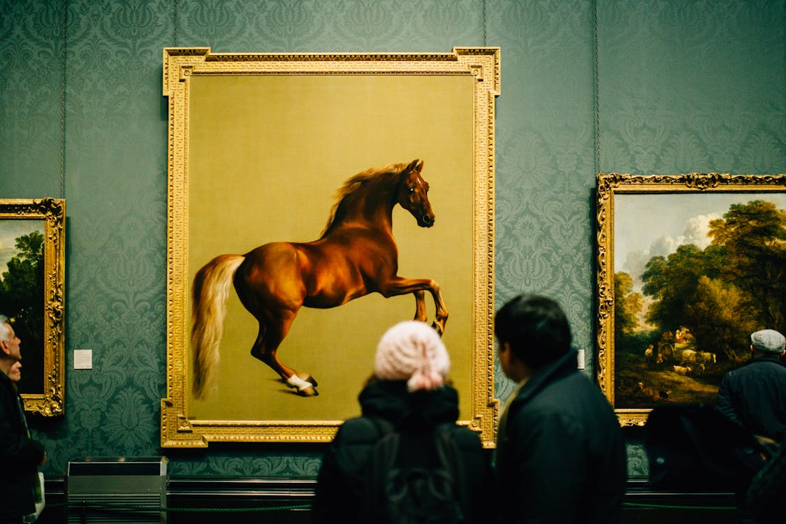 People observing fine art in a gallery