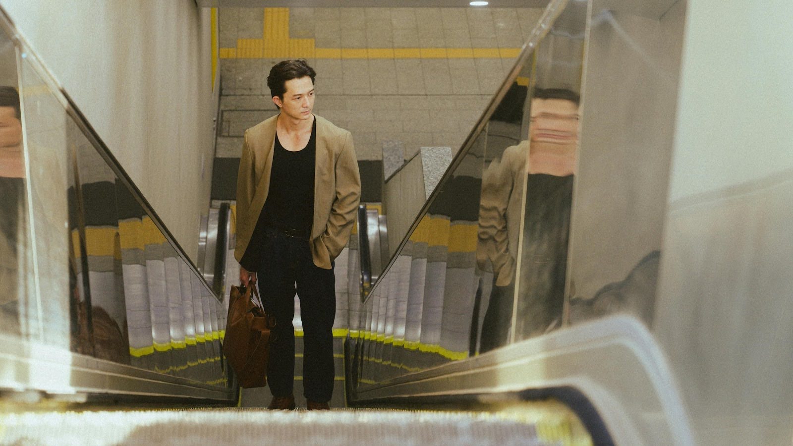a man riding an escalator