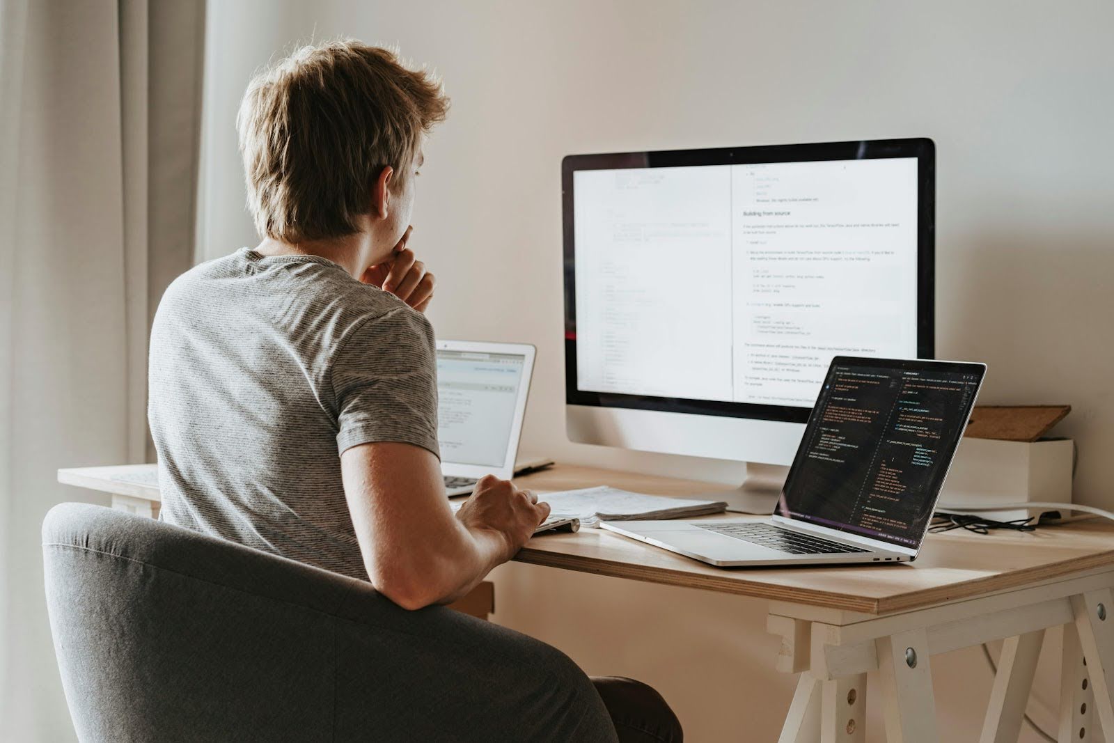 a man working with multple monitors